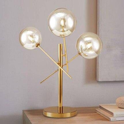 Lampe à poser design dorée et boules en verre
