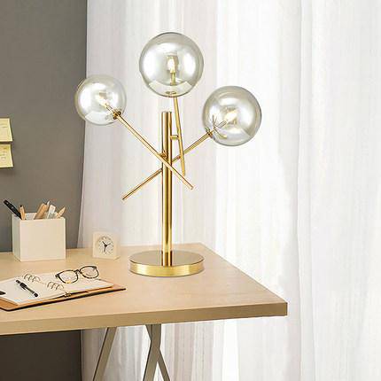 Lampe à poser design dorée et boules en verre
