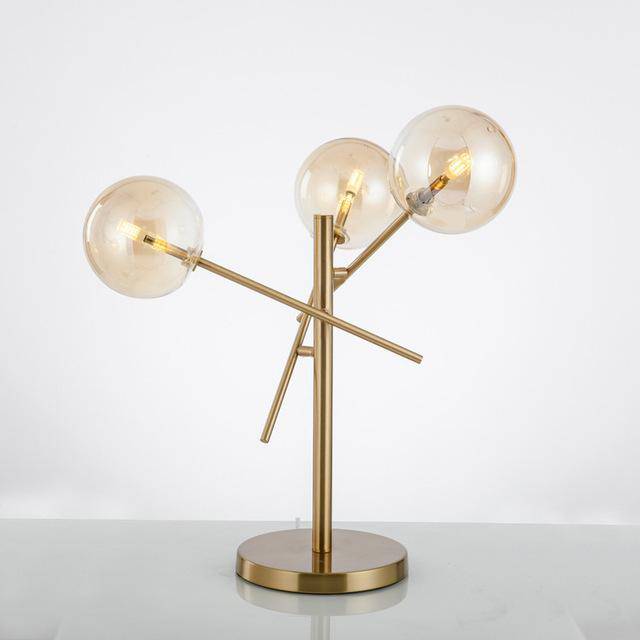 Lampe à poser design dorée et boules en verre
